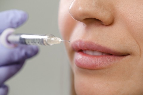 Types of lip augmentation procedures, woman getting filler injection.