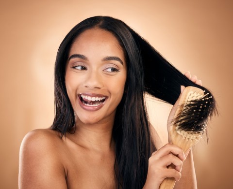 improve hair health, a woman brushing her hair